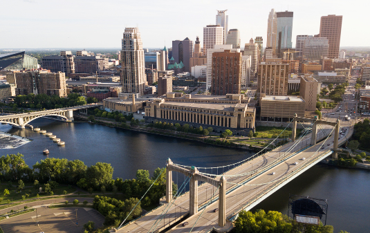 Minneapolis Nonprofit Staffing & Recruiting Agency image of downtown Minneapolis from aerial view with Mississippi River and bridges