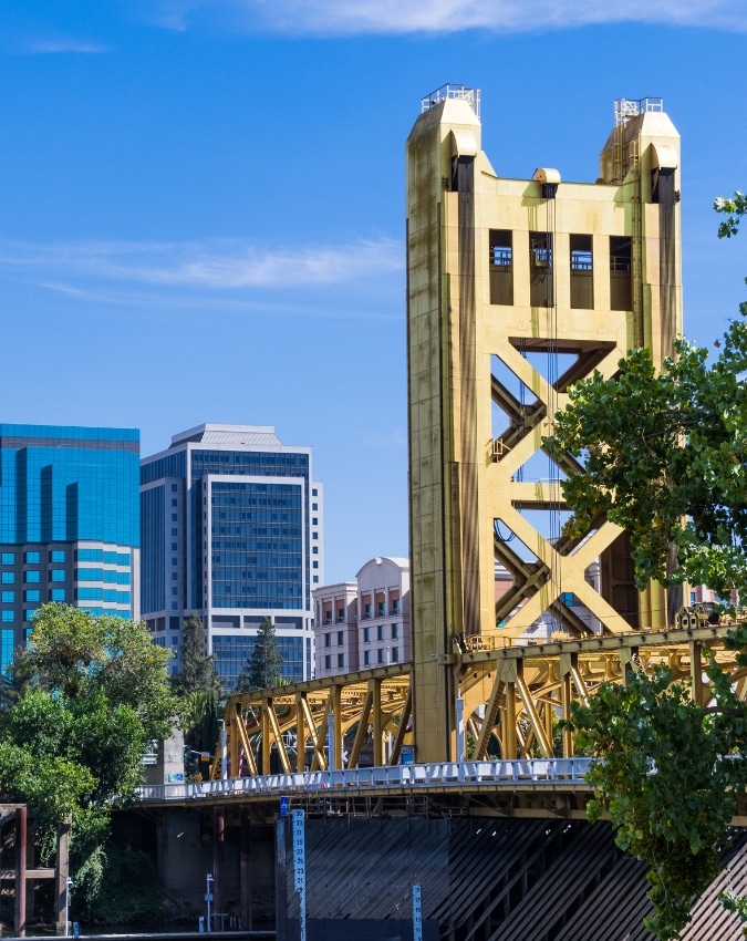 Scaramento Nonprofit Staffing and Recuriting. Landscape picture of the Sacramento bridge and organization buildings behind it.